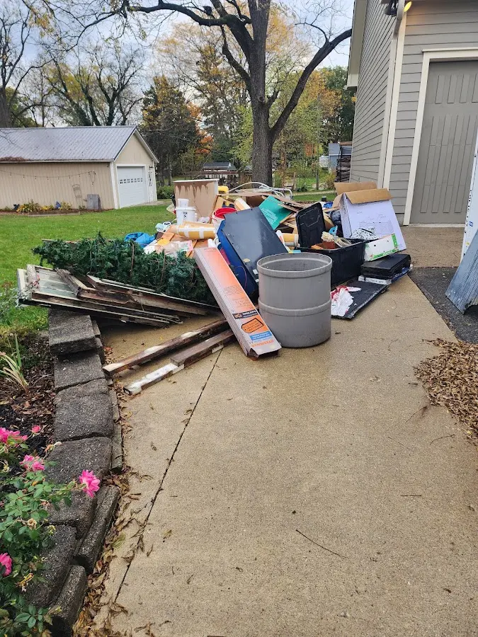 Dumpster being loaded with debris for Estate Cleanout Dumpster Rental in Holbrook